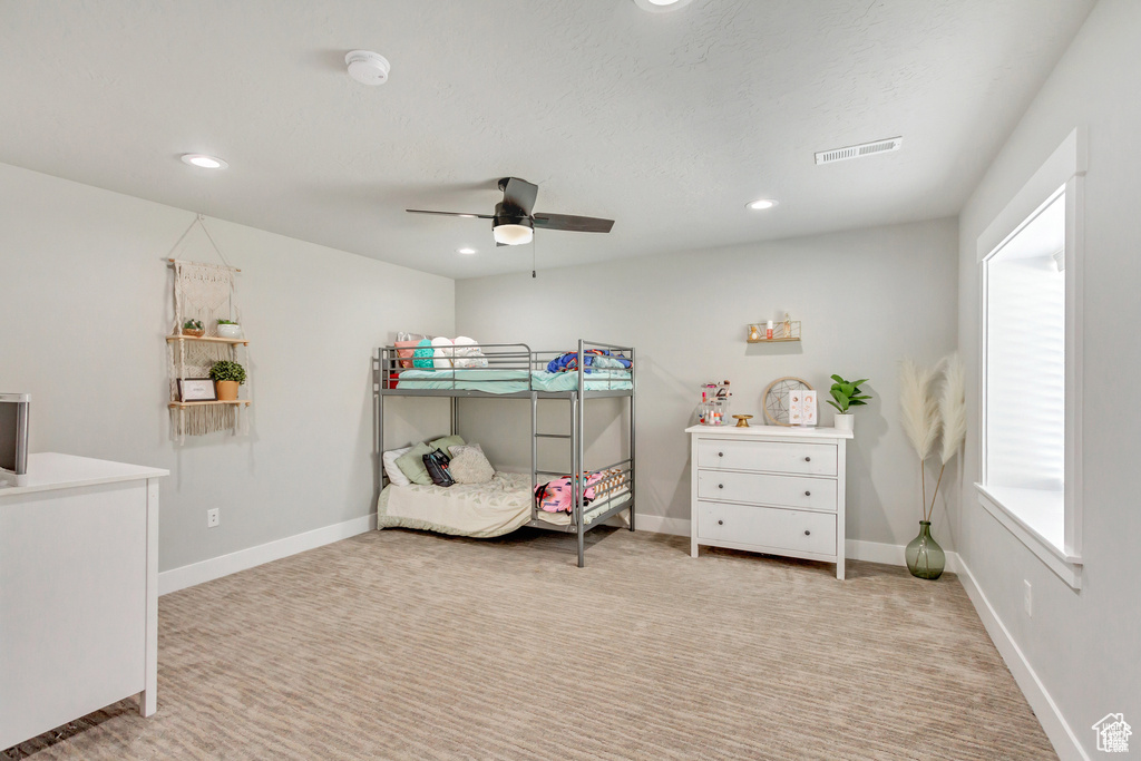 Bedroom featuring recessed lighting, light colored carpet, ceiling fan, and baseboards