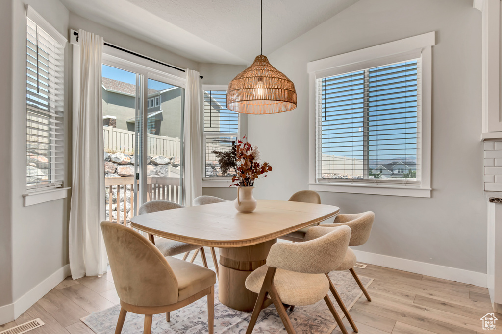 Dining space with baseboards and light wood finished floors