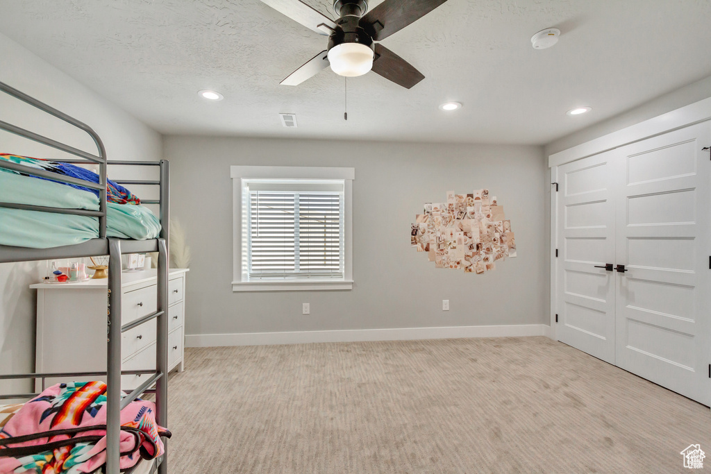 Unfurnished bedroom featuring recessed lighting, baseboards, light colored carpet, and a ceiling fan