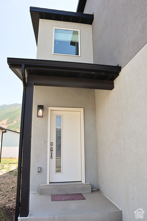View of exterior entry featuring stucco siding