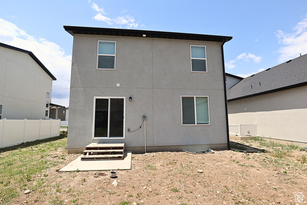 Rear view of house with stucco siding