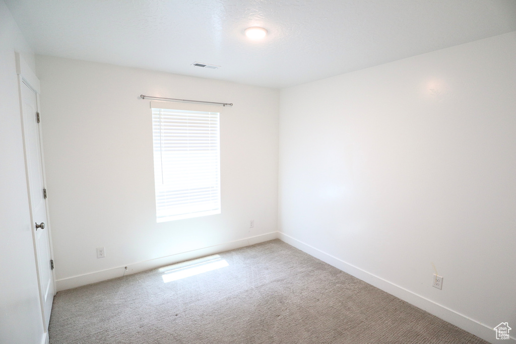 Unfurnished room with carpet and baseboards