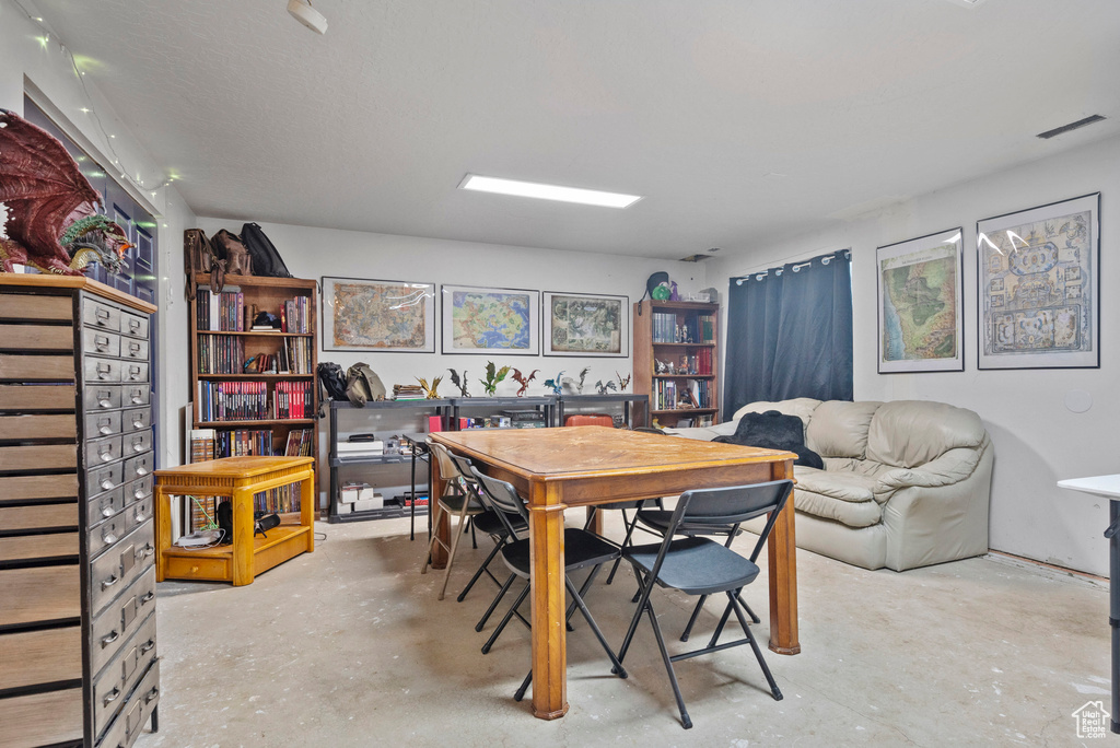 Dining room with unfinished concrete flooring