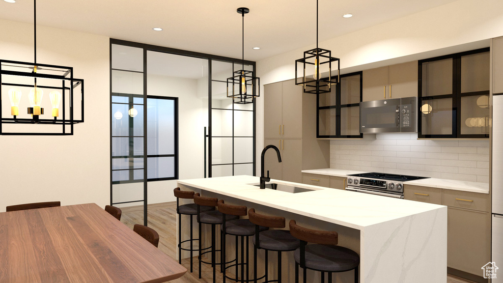 Kitchen with black microwave, a sink, stainless steel range, decorative backsplash, and light wood-style floors
