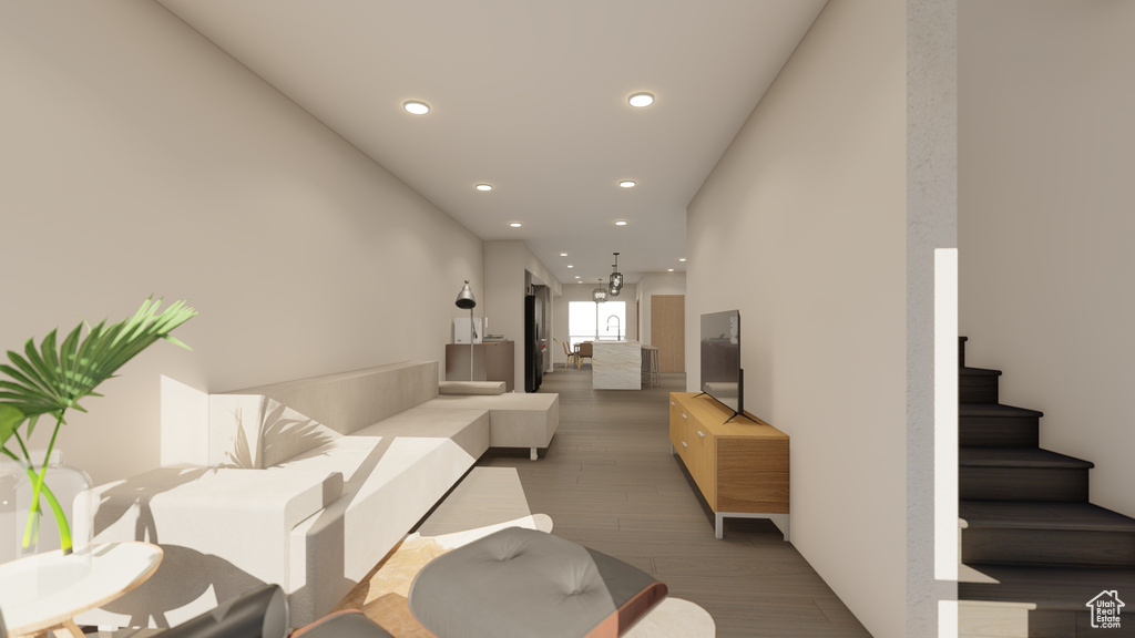 Living area with recessed lighting, light wood finished floors, and stairway