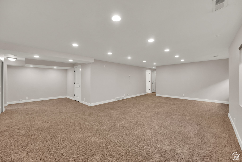 Finished below grade area featuring carpet floors, recessed lighting, and baseboards