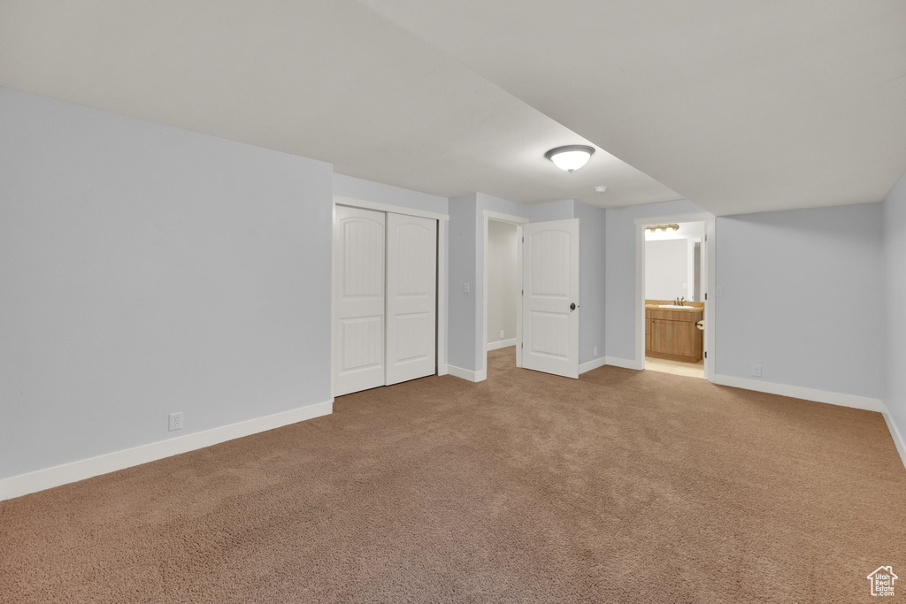 Below grade area featuring carpet floors and baseboards