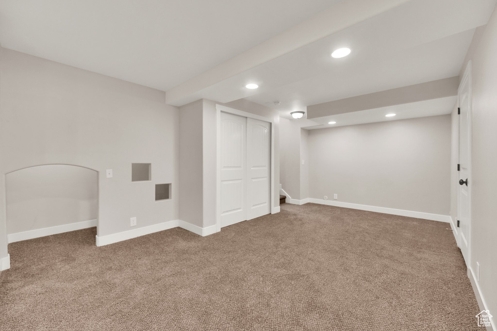 Finished below grade area with carpet floors, recessed lighting, and baseboards