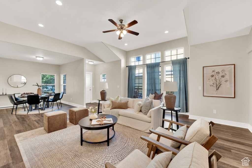 Living area with wood finished floors, a ceiling fan, baseboards, plenty of natural light, and recessed lighting
