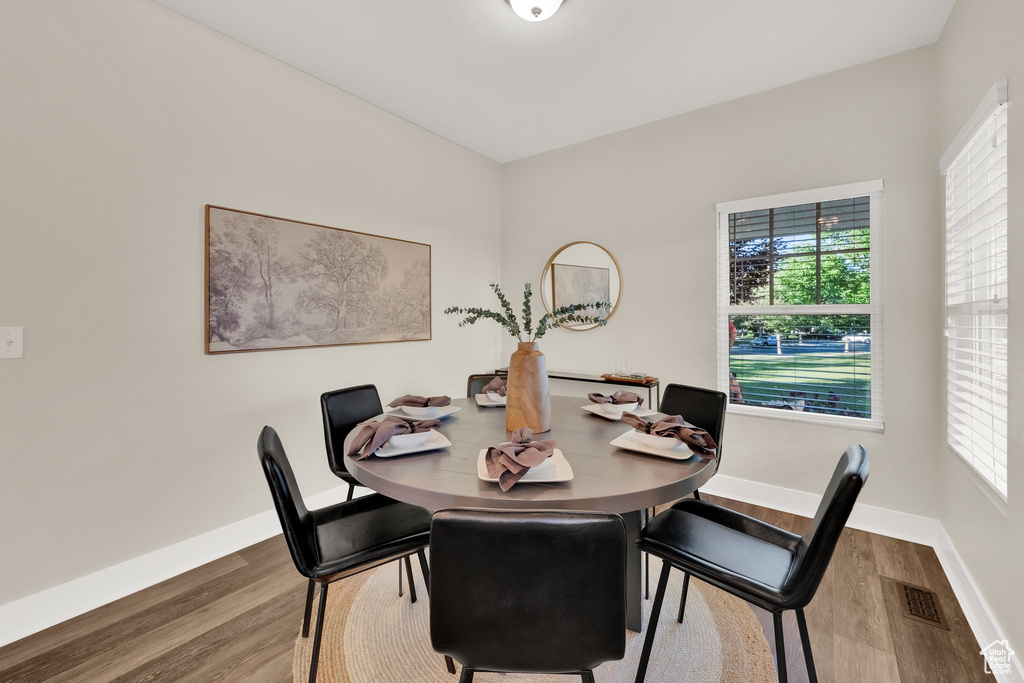 Dining space featuring wood finished floors and baseboards