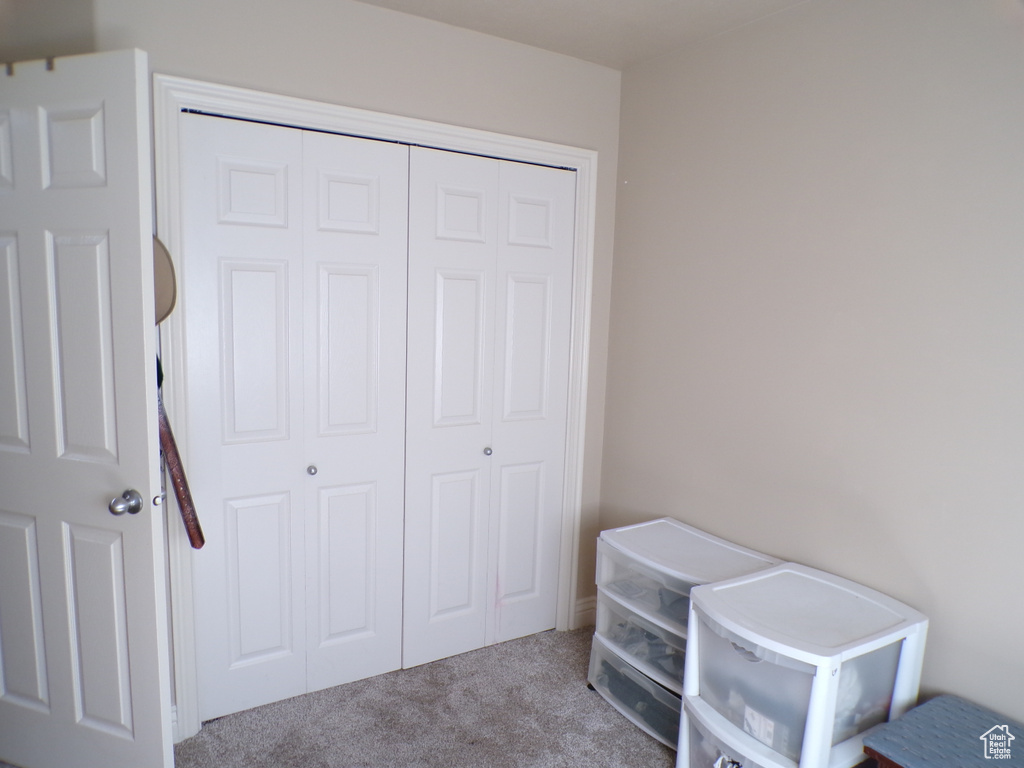 Bedroom with carpet flooring and a closet