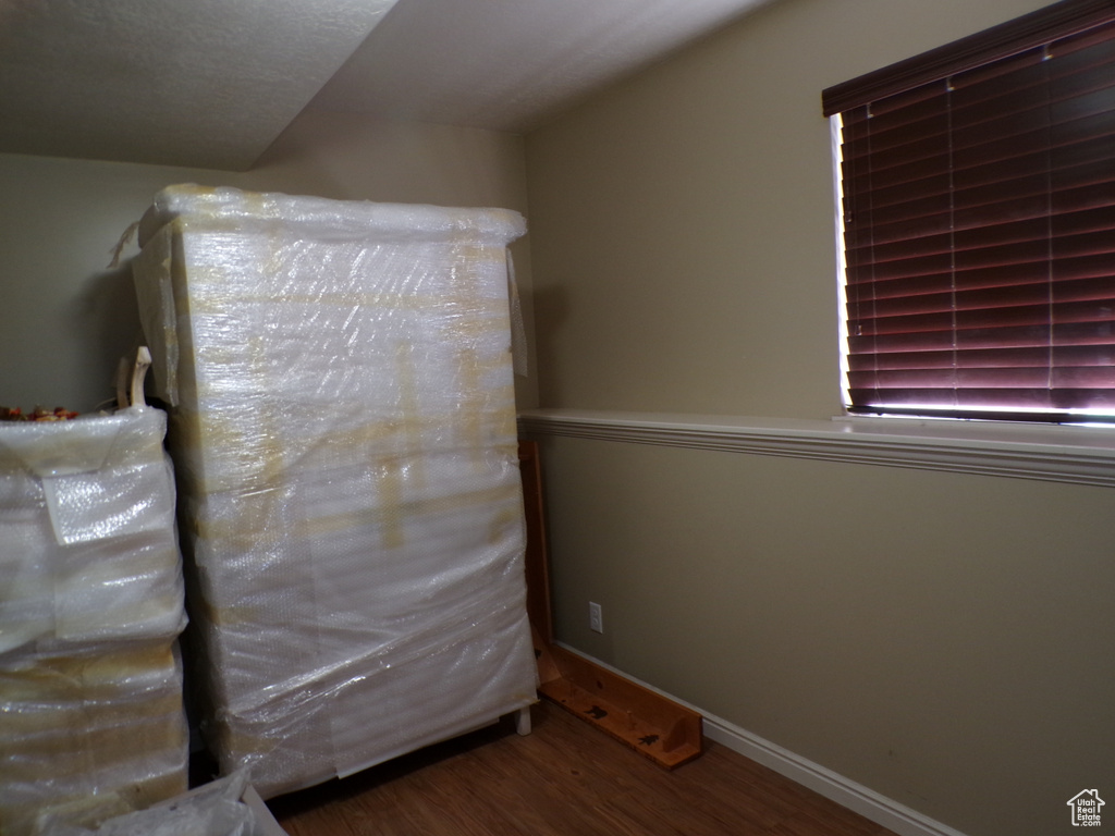 Unfurnished bedroom featuring wood finished floors and baseboards