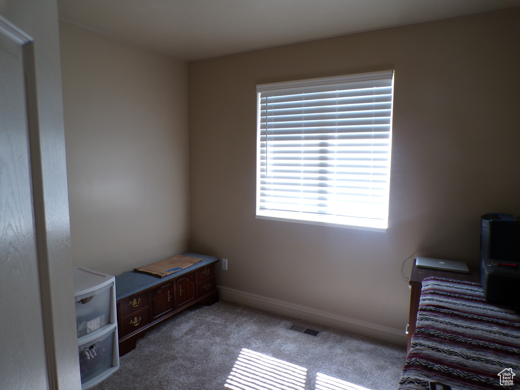 Carpeted bedroom with baseboards