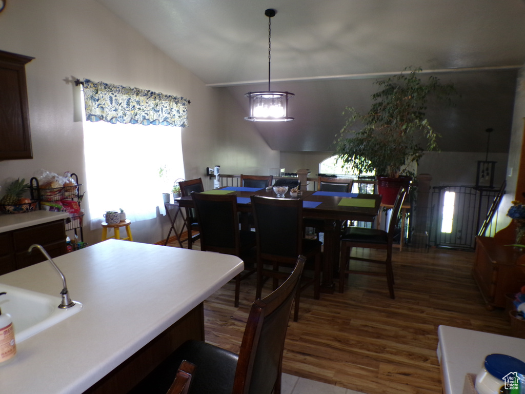 Dining room featuring lofted ceiling and wood finished floors