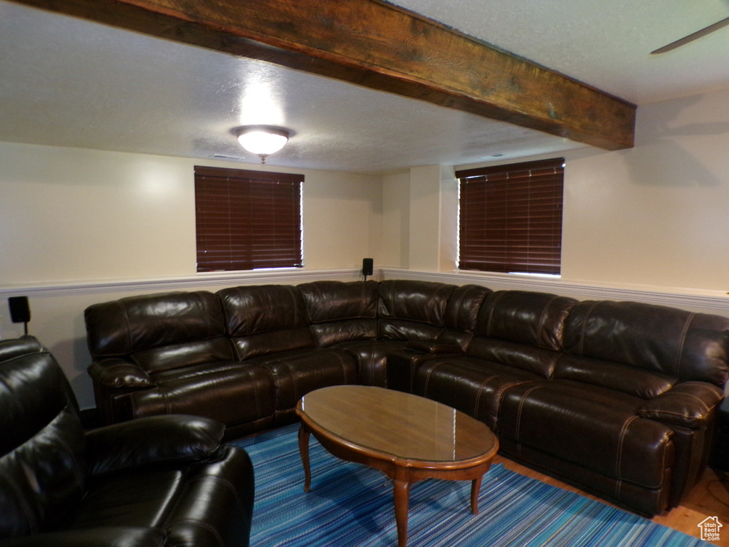 Living area featuring beamed ceiling