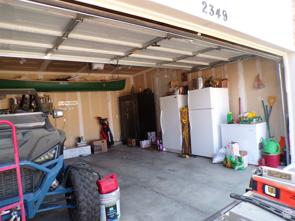 Garage featuring freestanding refrigerator and refrigerator