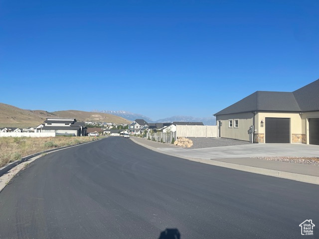 View of asphalt street with a mountain view and curbs