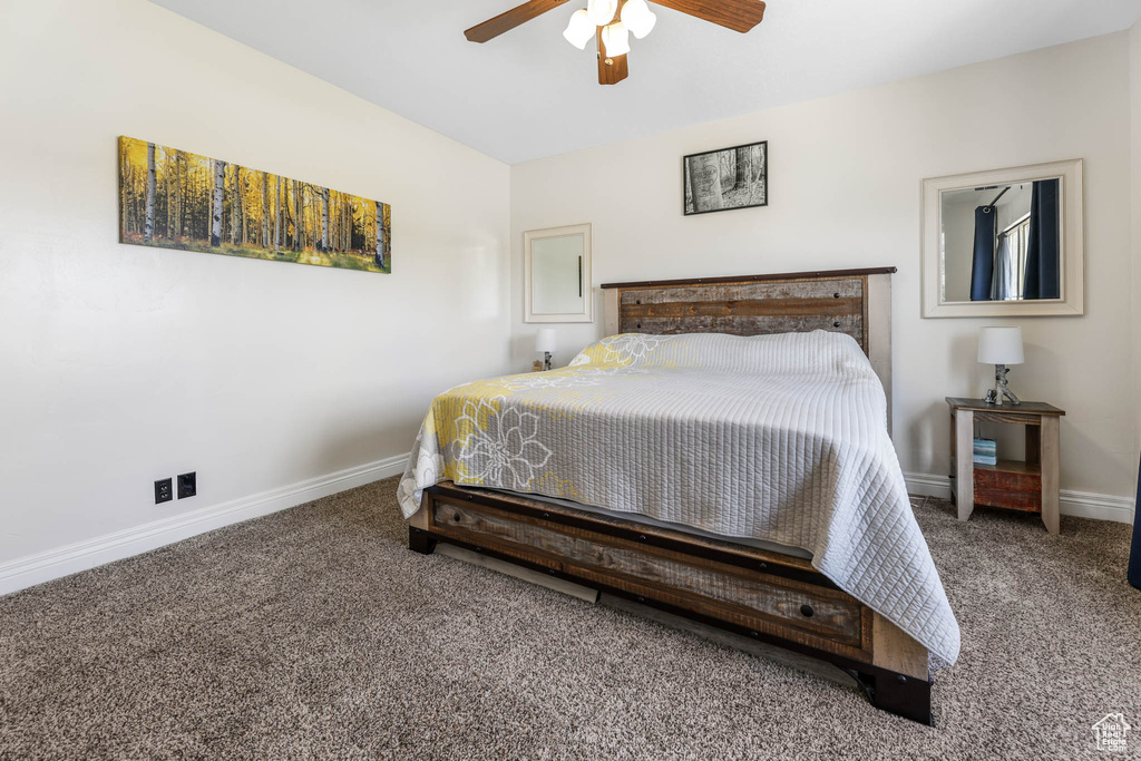 Bedroom featuring carpet, baseboards, and a ceiling fan