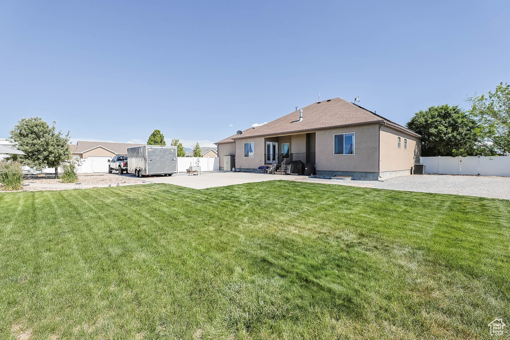 Back of property with a patio area, stucco siding, and central AC unit