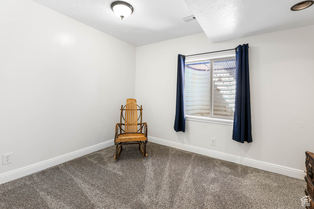 Unfurnished room featuring carpet and baseboards