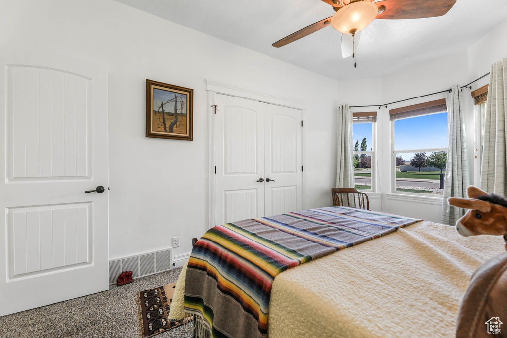 Bedroom with a closet, a ceiling fan, and baseboards