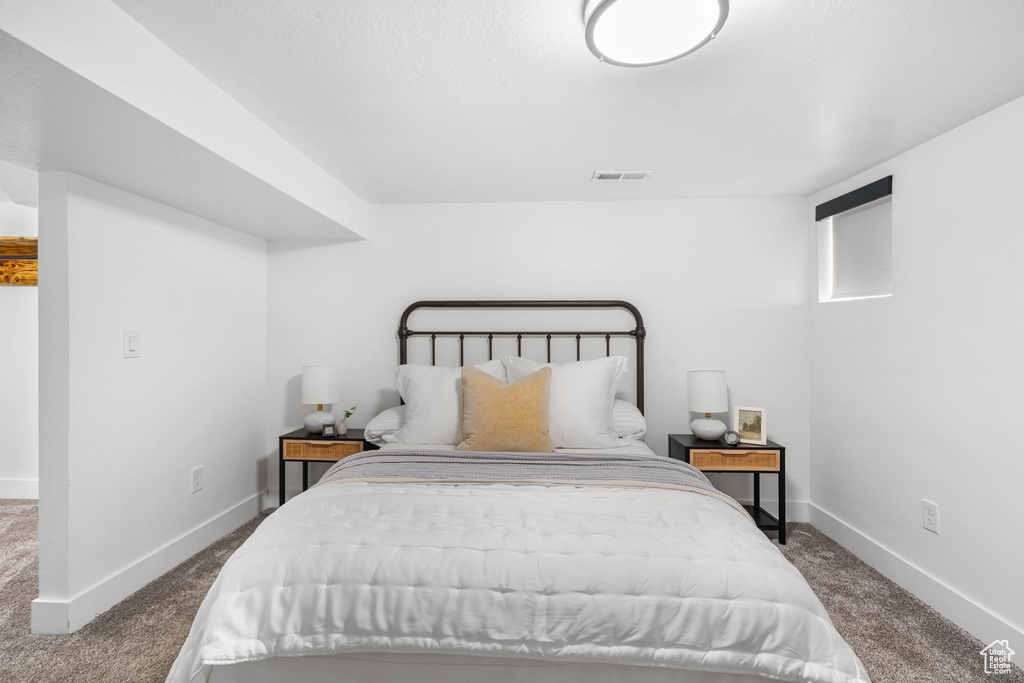 Carpeted bedroom featuring baseboards