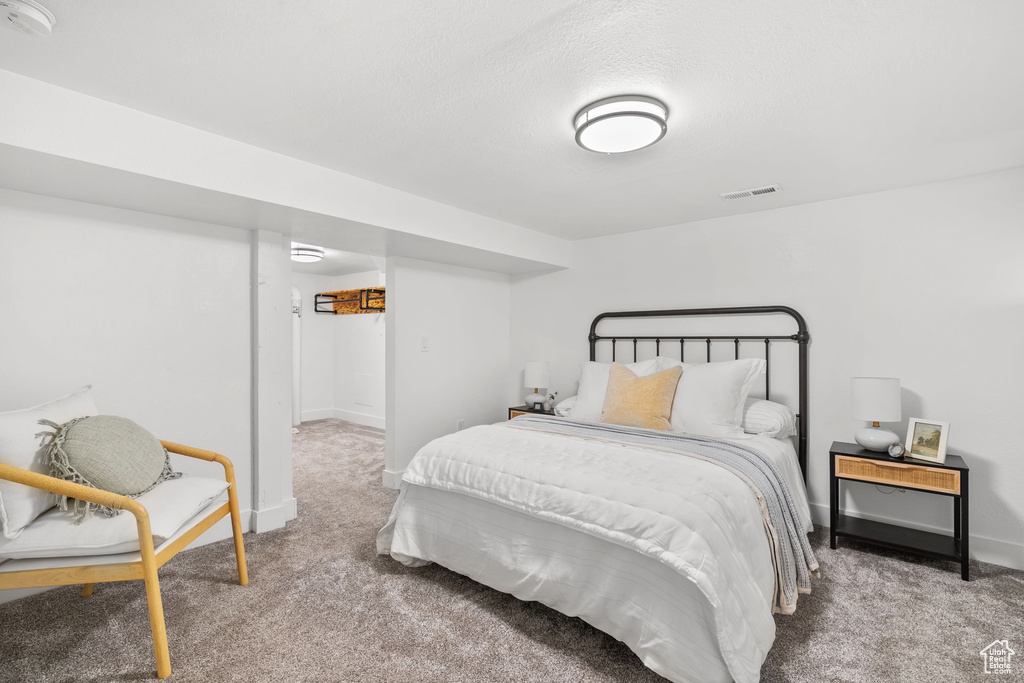 Carpeted bedroom featuring baseboards