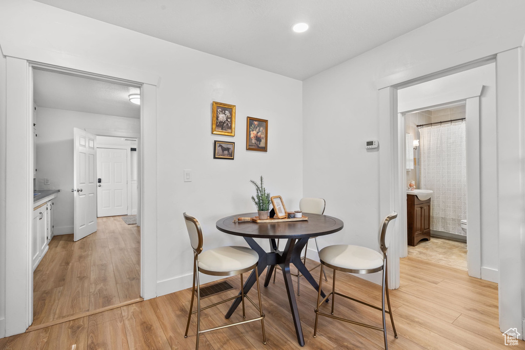 Dining space featuring light wood-type flooring and baseboards