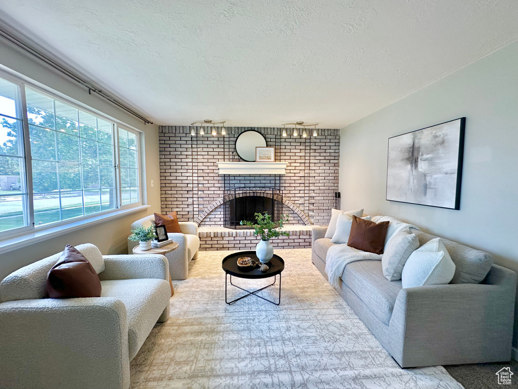 Living room with a textured ceiling and a fireplace