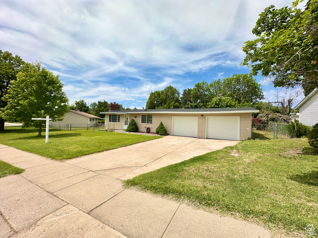 Single story home featuring driveway and an attached garage