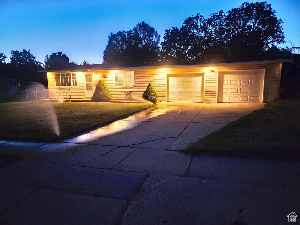 Ranch-style house featuring driveway and a garage