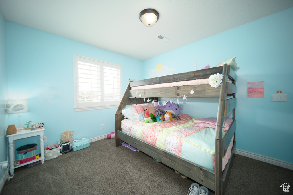 Carpeted bedroom featuring baseboards