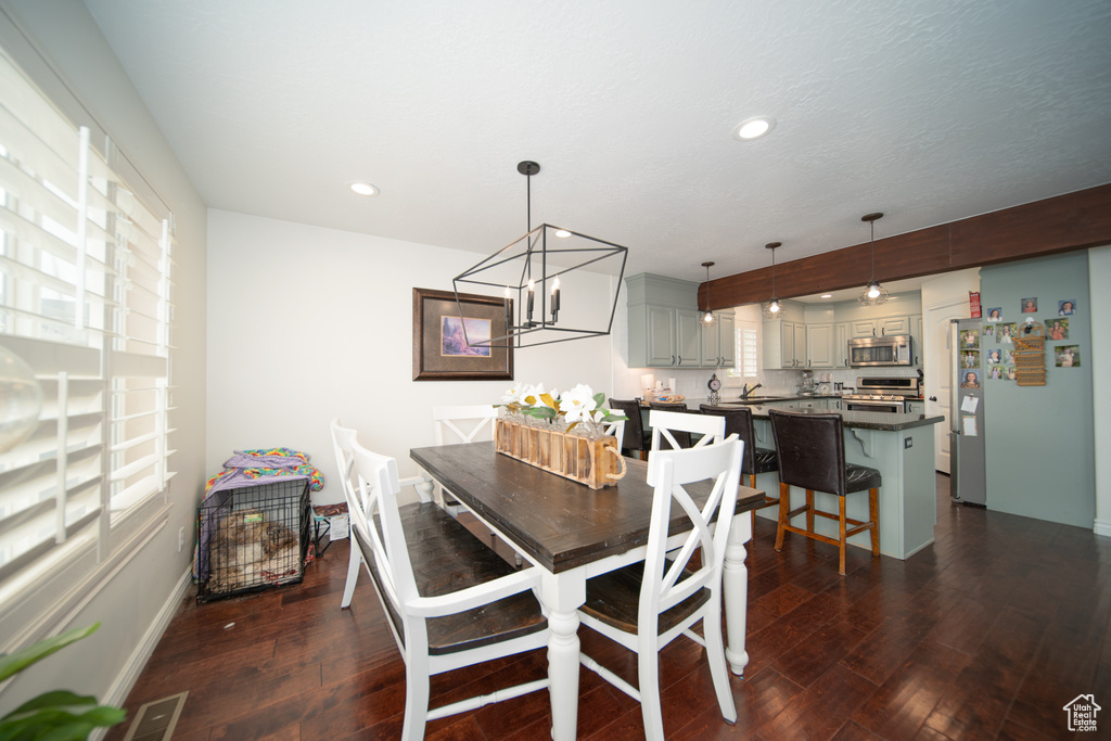 Dining space featuring dark wood finished floors, recessed lighting, and baseboards