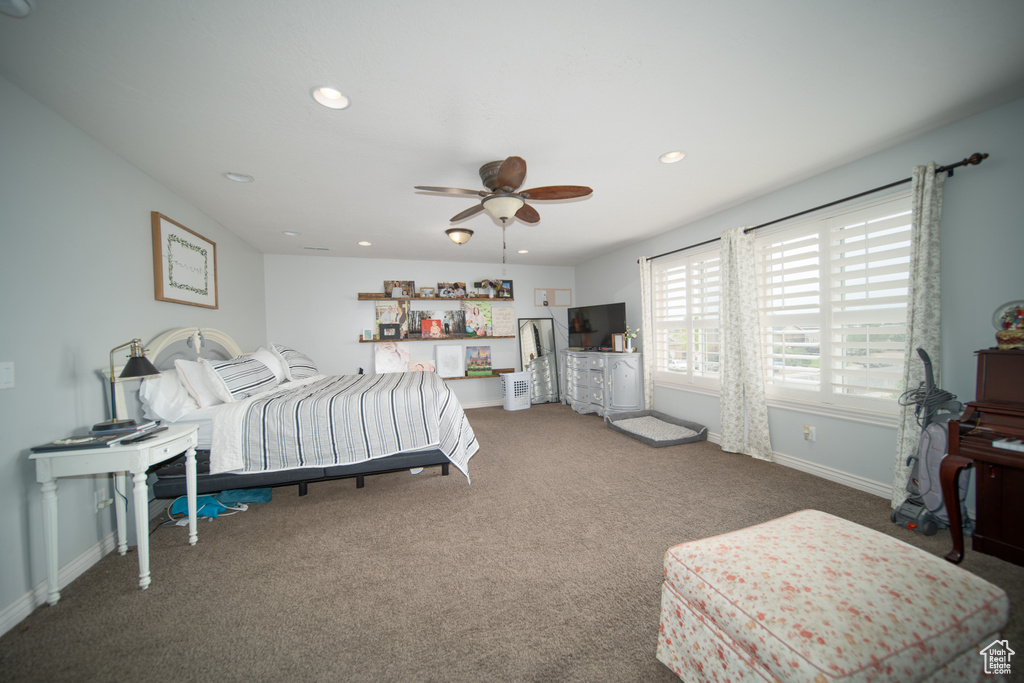 Carpeted bedroom featuring baseboards, recessed lighting, and ceiling fan