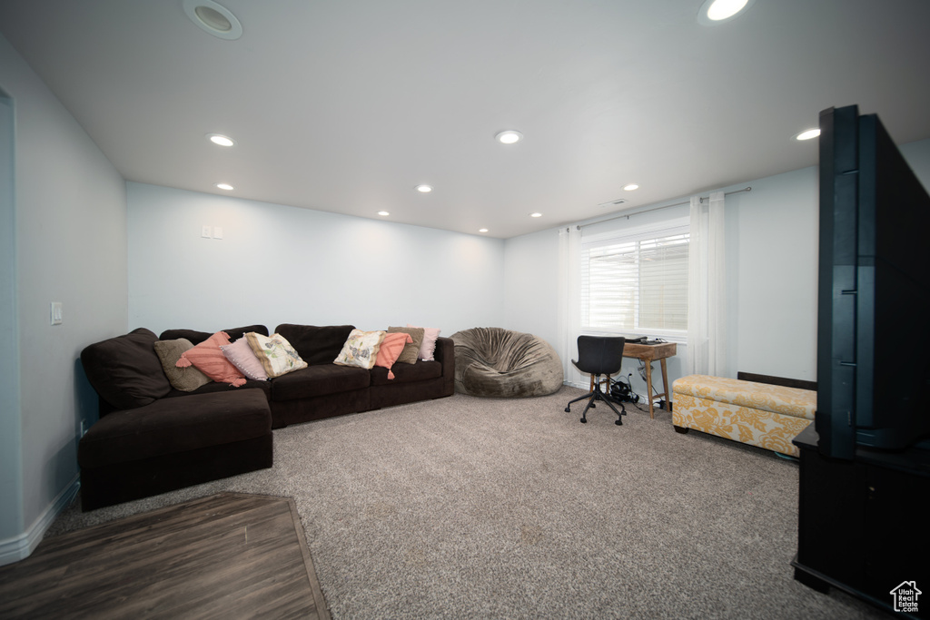 Carpeted living room featuring recessed lighting