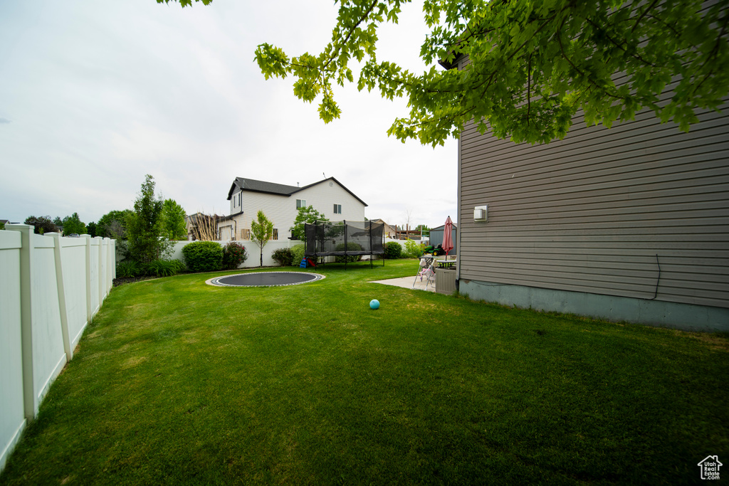 View of yard featuring a trampoline