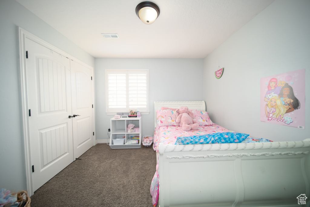 Bedroom with carpet floors and a closet
