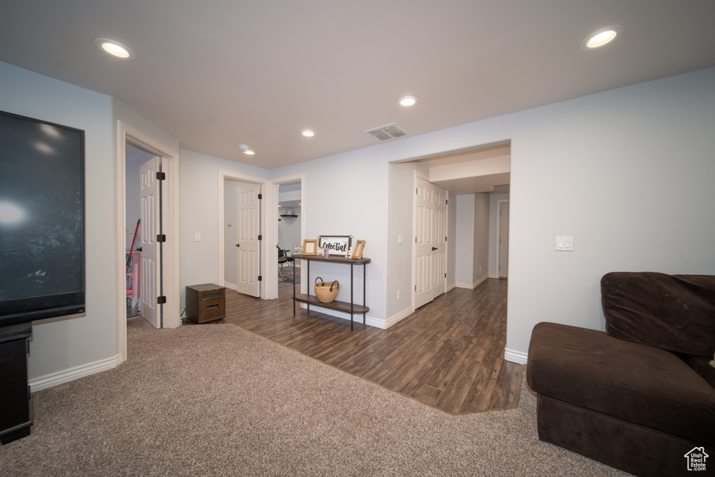 Living area with carpet flooring, recessed lighting, baseboards, and wood finished floors