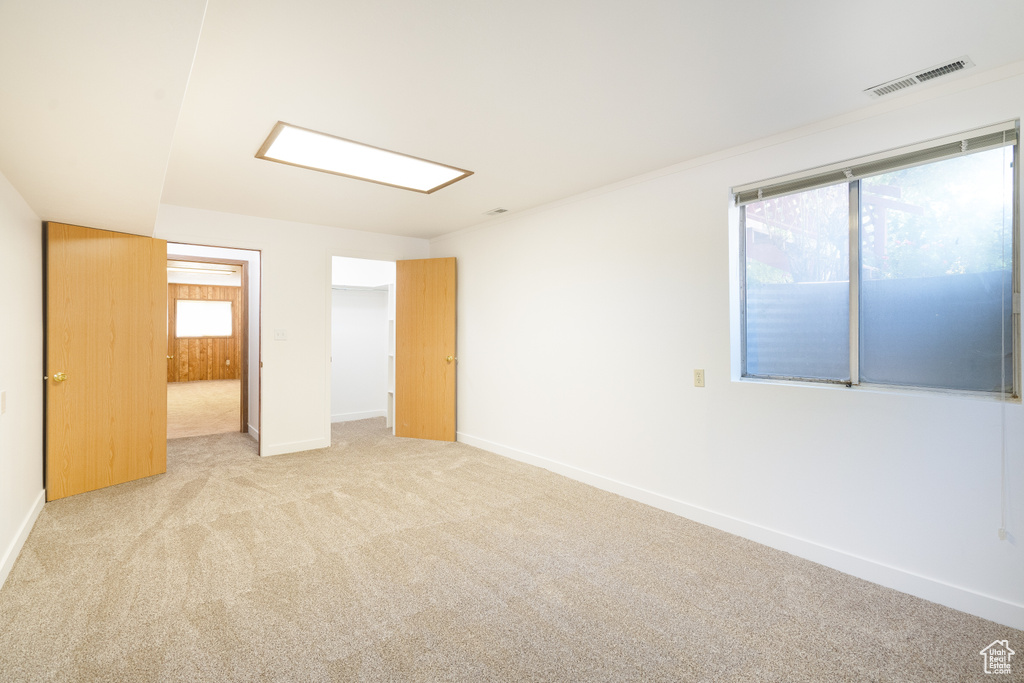 Unfurnished bedroom with carpet floors, baseboards, and a spacious closet