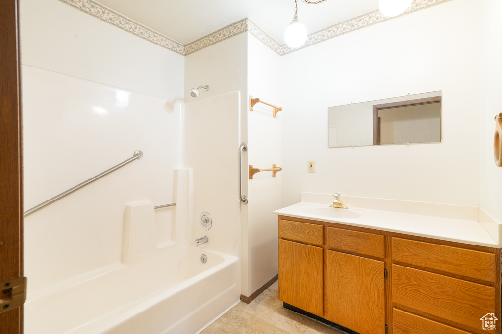 Full bath featuring vanity and bathing tub / shower combination
