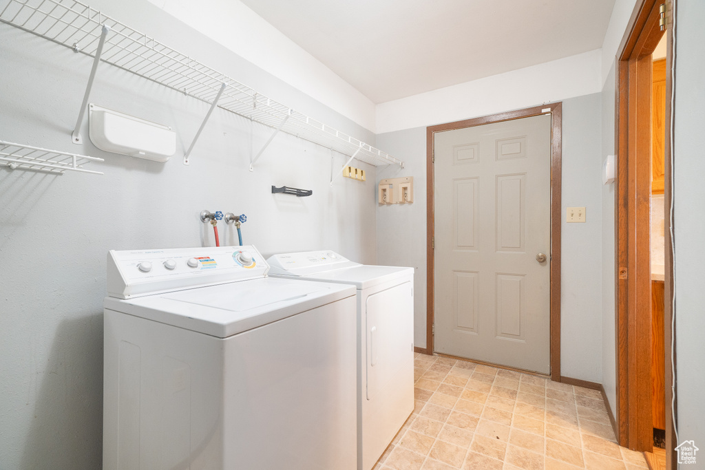 Washroom featuring washer and clothes dryer and baseboards