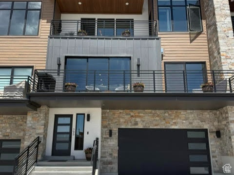 View of building exterior with a garage and driveway