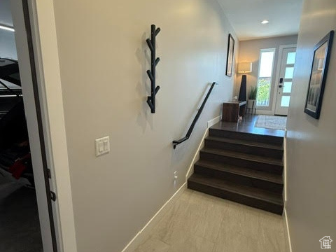 Stairway featuring baseboards and recessed lighting