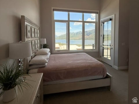 Bedroom with access to outside, baseboards, a ceiling fan, a water view, and dark carpet