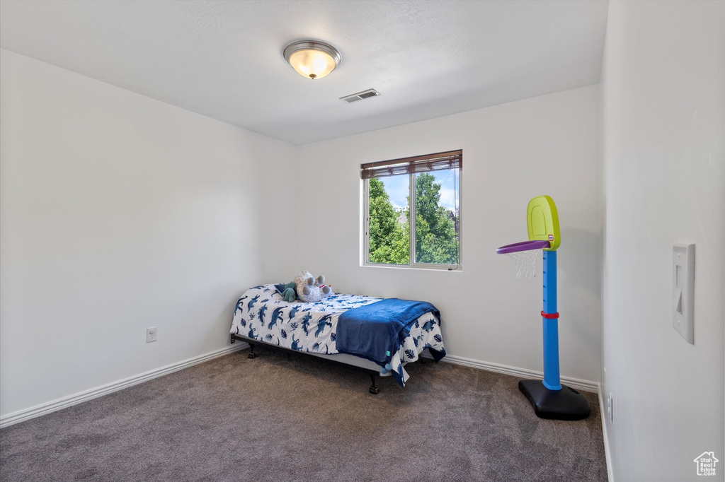 Carpeted bedroom with baseboards