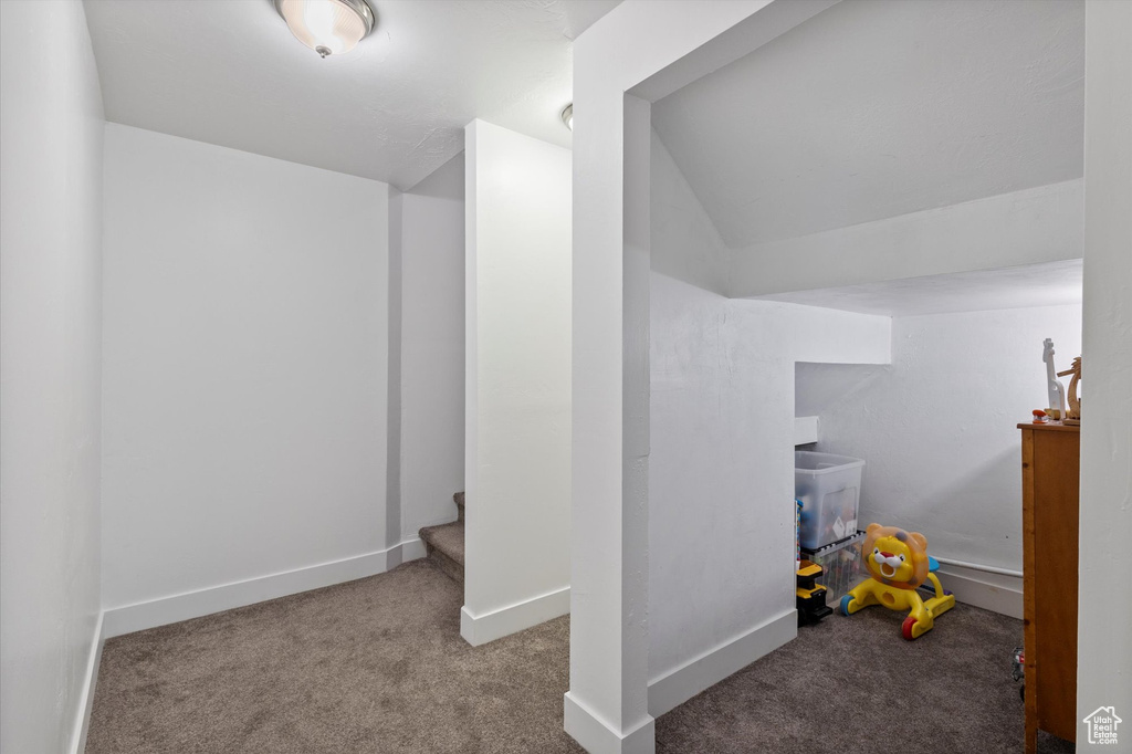 Bonus room featuring carpet floors, vaulted ceiling, and stairs