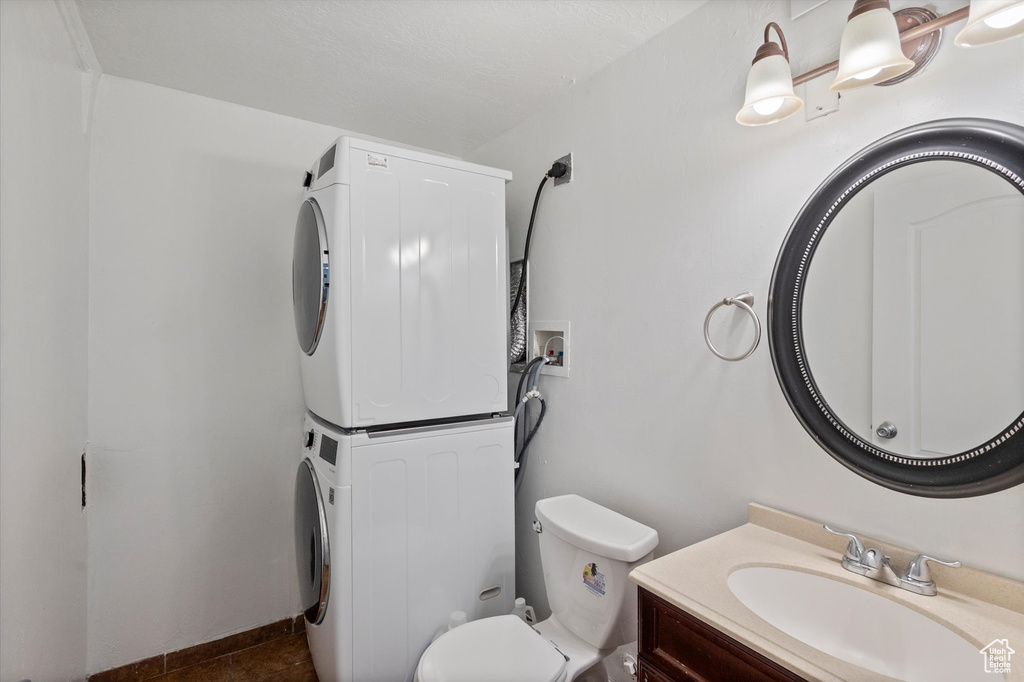 Bathroom with stacked washer / drying machine and vanity