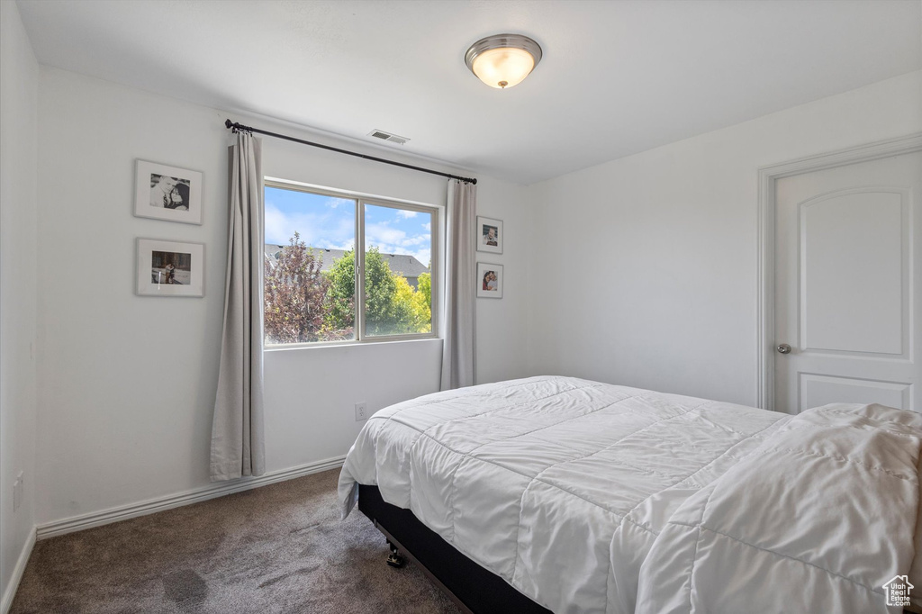 Bedroom with carpet floors and baseboards