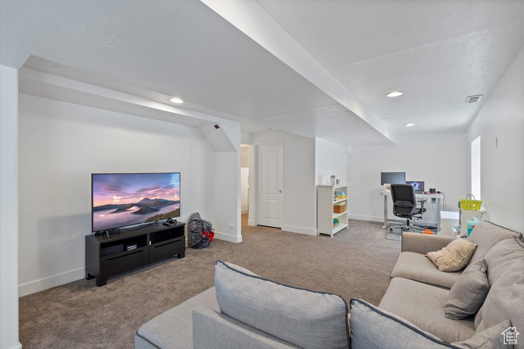 Carpeted living room with a desk and recessed lighting