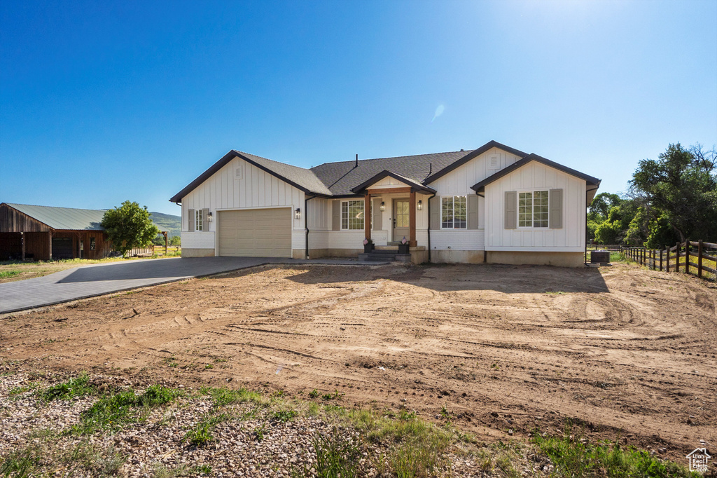 View of front facade with driveway and an attached garage